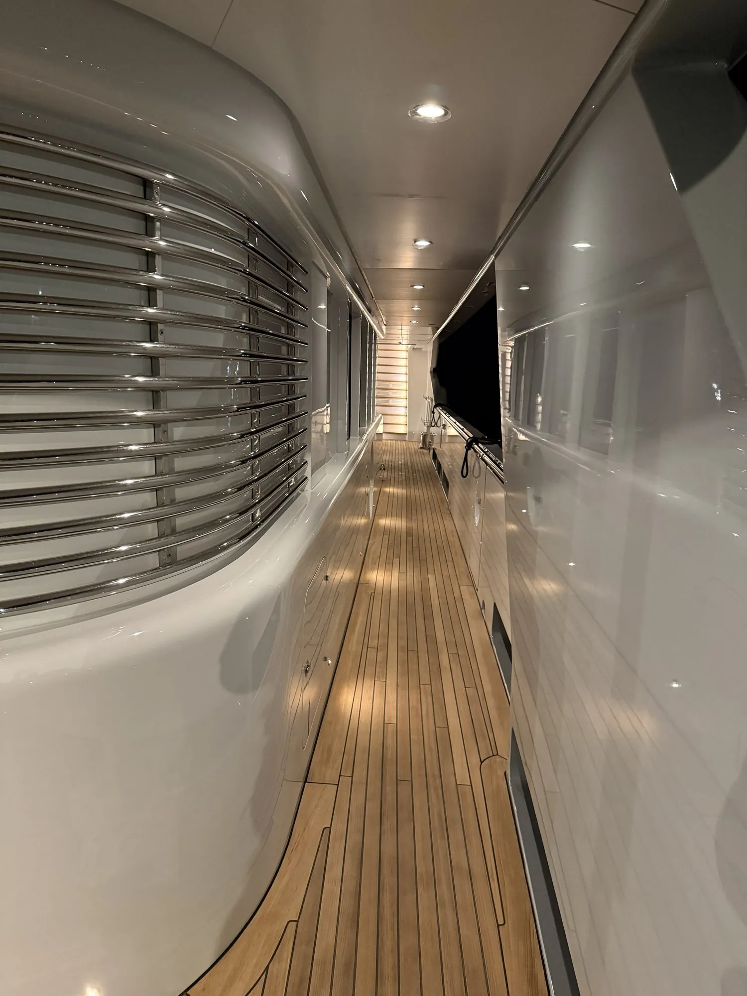 Long narrow teak side-deck walkway running to a vanishing point
