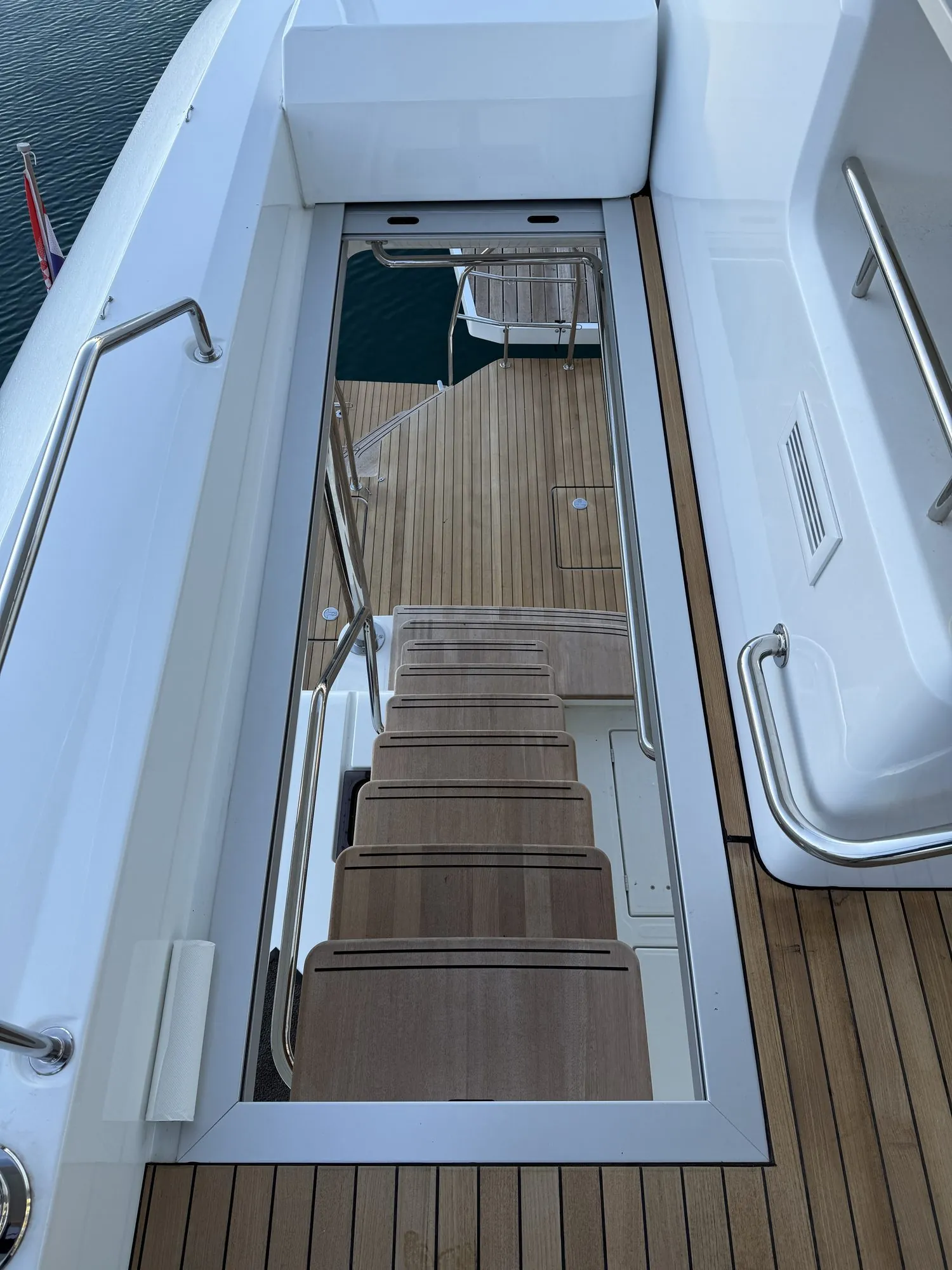 Teak transom steps going down to the water