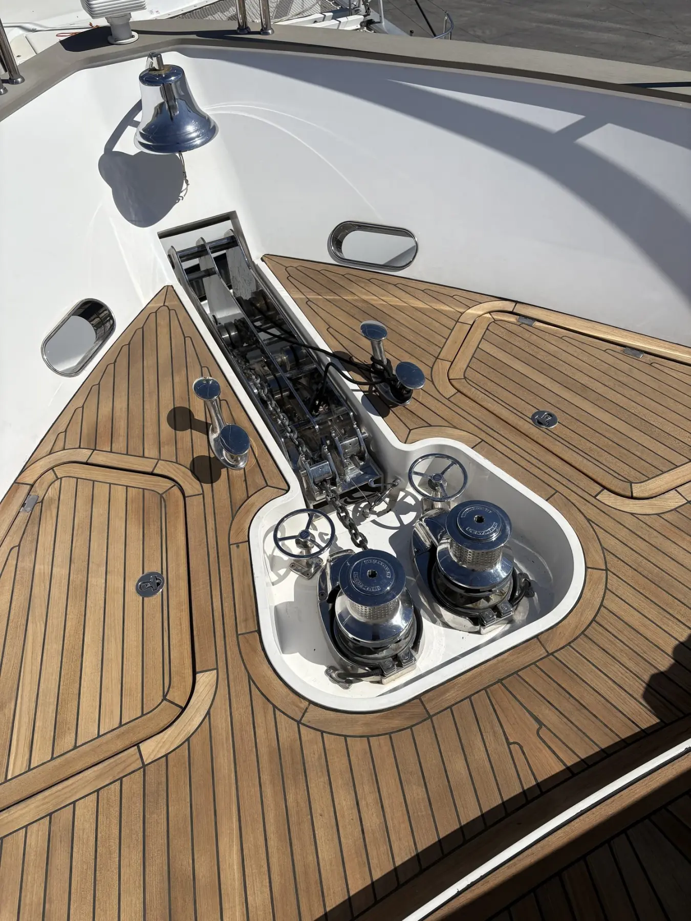 Black caulk seams bending around a windlass recess